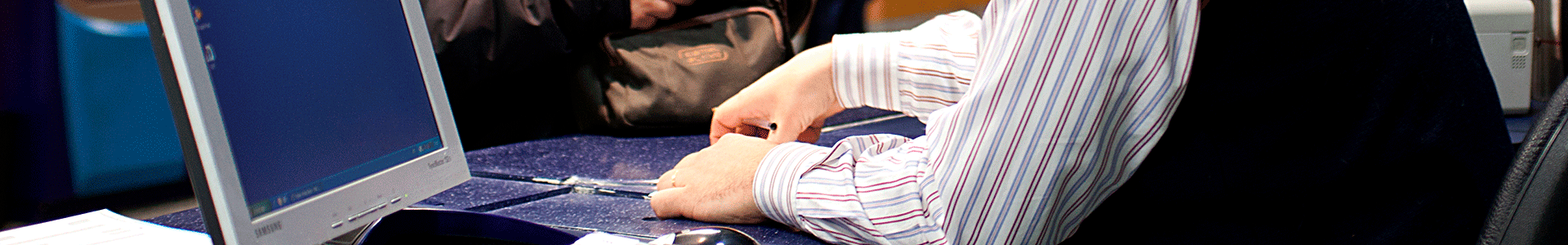 Close up image of a Metro employee assisting a passenger at a Customer Support Center