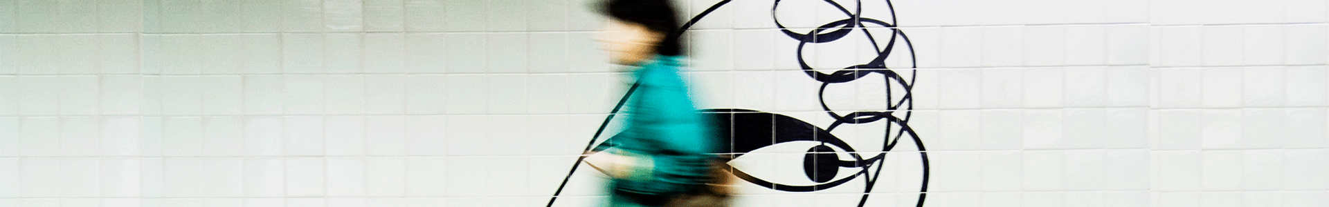  Blurred image of female passenger walking on the platform of a station.